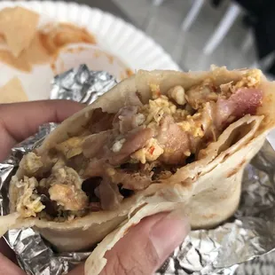 Inside. Bacon and sausage. They include beans in the breakfast burrito which is AWESOME! Yum!
