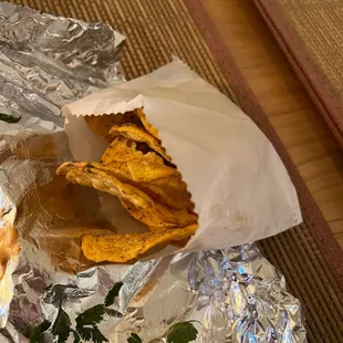 a hot dog wrapped in tin foil