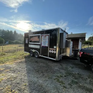 a taco truck parked in a field