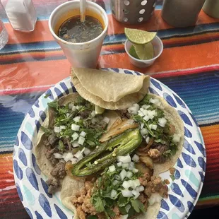 a plate of tacos and salsa
