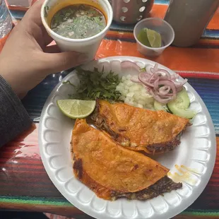 a person holding a cup of soup