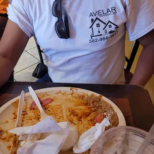 a man sitting at a table with a plate of food