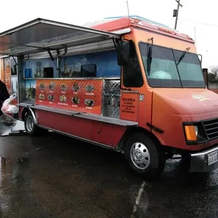 a man standing in front of a food truck