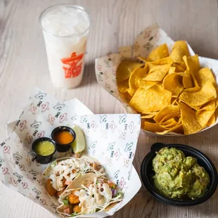 Shrimp tacos, horchata, chips and guac.
