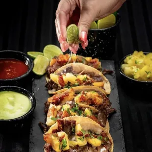 a hand sprinkling a lime