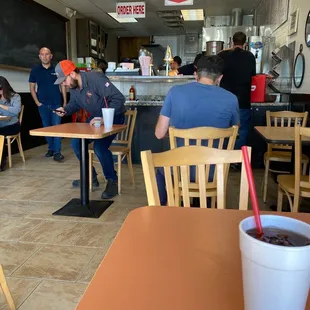 people sitting at tables in a restaurant