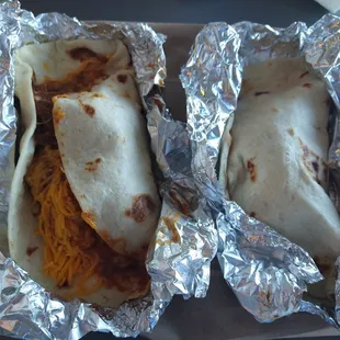 two burritos wrapped in foil