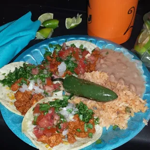 My yummy plate of tacos, beans, rice, salsa and freshly grilled jalapeno from tacosntunes.