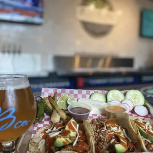 a glass of beer and a plate of food