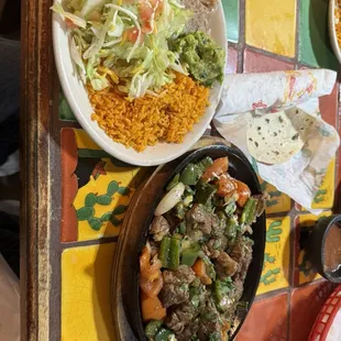 Guillotos platter, sirloin so tender it falls apart with peppers, onions and tomatoes