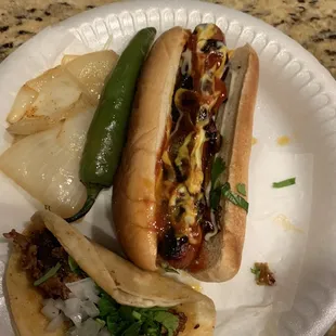 Hot Dogs with Bacon are delicious &amp; the Tacos de Pastor are good .