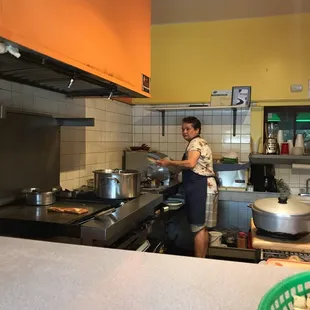 a woman preparing food in a kitchen