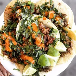 Yummy Tacos topped with both red and green salsa!