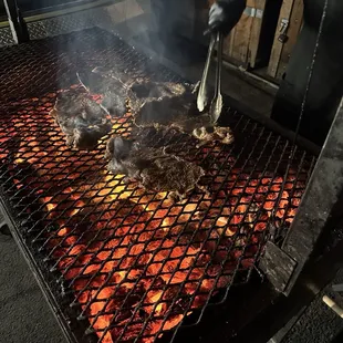 Carne asada cooking over charcoal