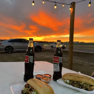 two bottles of coke and a sandwich