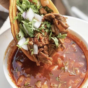 a hand holding a tortilla