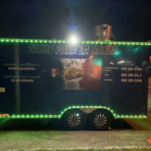 a taco truck with neon lights