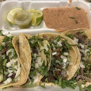 Two barbacoa, suadero, asada, beans