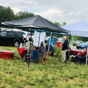 a group of people sitting under a tent