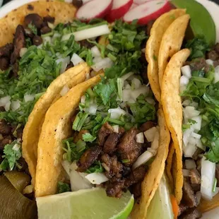 1 carne asada and 4 al pastor tacos