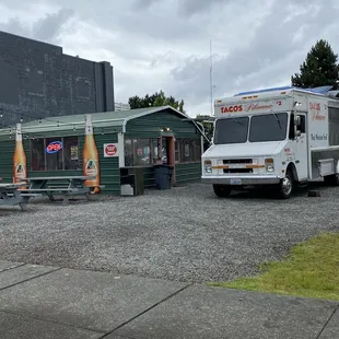 two food trucks parked in a parking lot