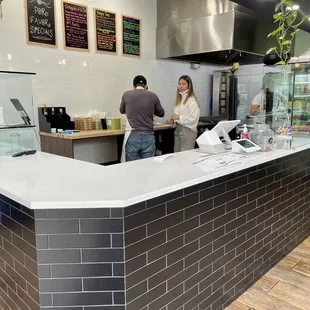 two people standing at a counter