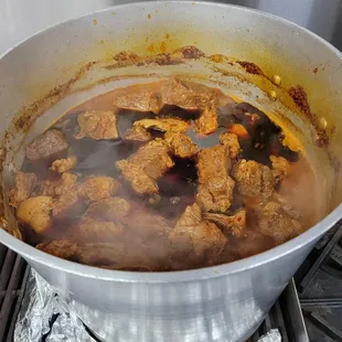a pot full of meat and vegetables