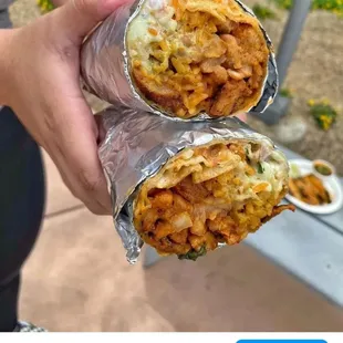 a person holding a burrito