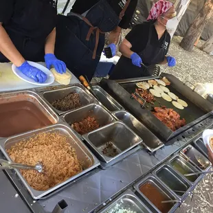 a group of people preparing food