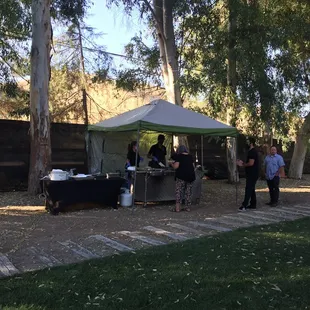 a group of people standing under a tent