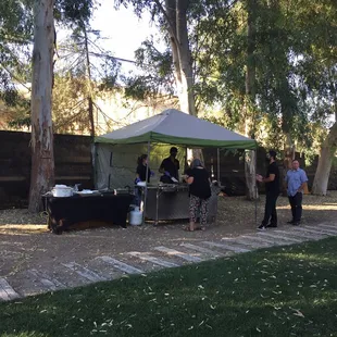 a group of people standing under a tent