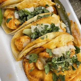 a row of tacoss on a plate