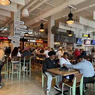 people sitting at tables in a restaurant