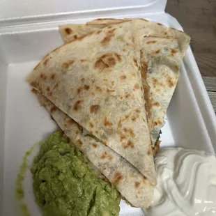 two quesadillas in a styrofoam container