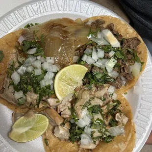 a plate of tacos with meat and onions