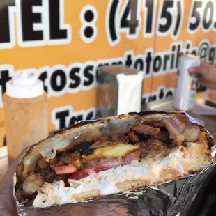 a hand holding a burrito