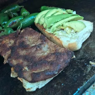 a burger and green peppers