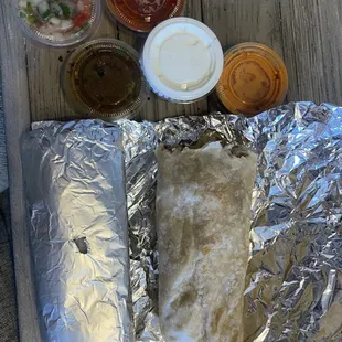 asada burrito and pollo burrito with multiple salsas from salsa bar