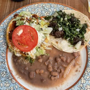 Barbacoa taco, al pastor sope, and beans