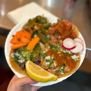a person holding a plate of food