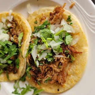 two tacoss on a plate