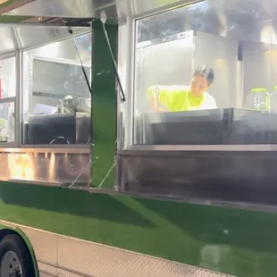 a green and white food truck