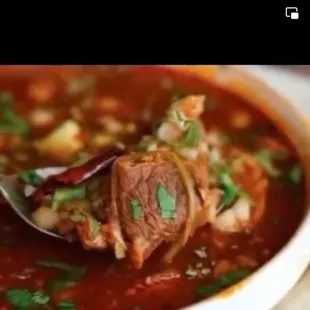 a bowl of soup and tortillas