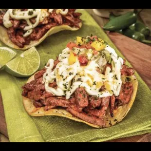 Volcanoes

A hard crispy tortilla meat of your choice on the top and a melted cheese on top served with cilantro and onions on top