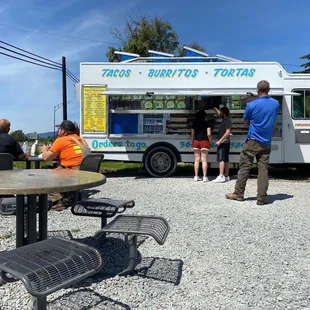 people ordering food from a food truck