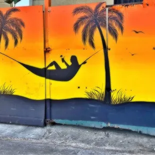 a man in a hammock between palm trees