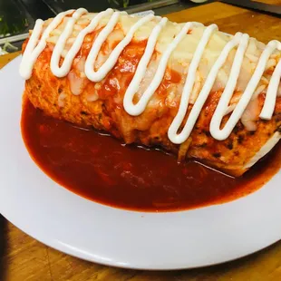 a plate of enchiladas with sauce