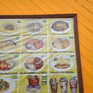 a menu on a yellow wall