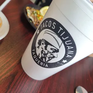 a cup of tacos sitting on a table