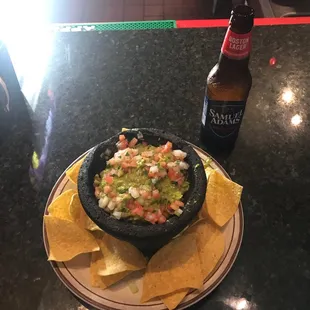 Fresh Guacamole with limes, jalapeño, tomatoes and cilantro, and fresh onions.